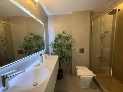 a bathroom with a sink and a toilet and a mirror at The Point Tower Dubai Marina in Dubai