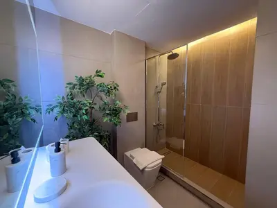 a bathroom with a shower and a toilet and a sink at The Point Tower Dubai Marina in Dubai