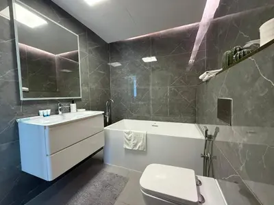 a bathroom with a sink and a toilet and a tub at The Point Tower Dubai Marina in Dubai