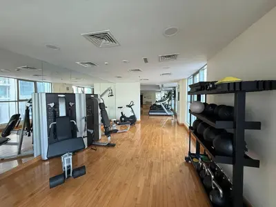 a gym with lots of treadmills and exercise equipment at The Point Tower Dubai Marina in Dubai