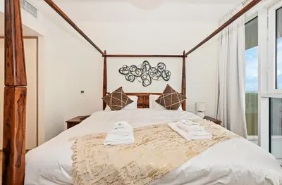 a bedroom with a large bed with towels on it at Bloomfields Luxurious 3BR in West Residences in Dubai