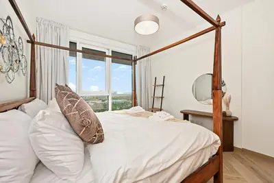 a bedroom with a canopy bed and a mirror at Bloomfields Luxurious 3BR in West Residences in Dubai