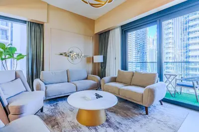 a living room with couches and a table at TRPS - Act Towers, Downtown Dubai - Full Burj Khalifa View, High-End 3BR plus Maids in Dubai