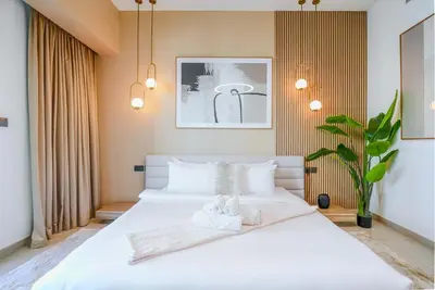 a bedroom with a white bed with two towels on it at TRPS - Act Towers, Downtown Dubai - Full Burj Khalifa View, High-End 3BR plus Maids in Dubai