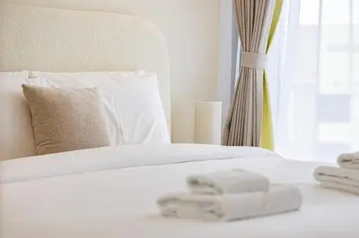 a white bed with white sheets and a window at Iconic Binghatti Royale! Private Pool in Your Balcony! 5 Star Amenities! in Dubai