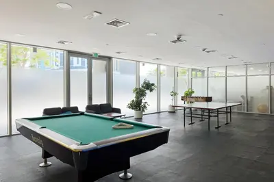 a pool table in a room with glass windows at Modern Smart & Spacious 1BR Business Bay near Downtown Dubai in Dubai