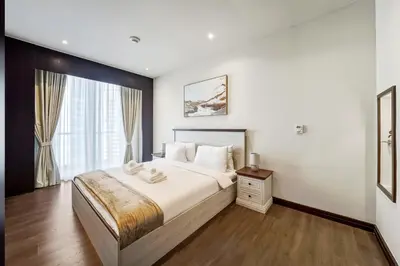 a bedroom with a large bed and a window at Modern Smart & Spacious 1BR Business Bay near Downtown Dubai in Dubai