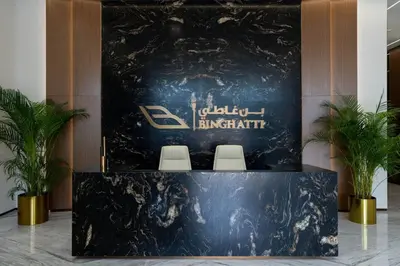 a display in a lobby with two chairs and a sign at Soft-Toned 1BR in Binghatti Gardenia with Pool & Gym in Dubai