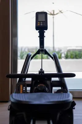 a camera on a tripod in front of a window at Binghatti Azure Minimal Luxe Studio with Pool & Gym in Dubai