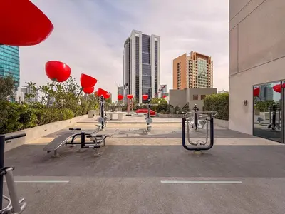 a group of benches in a city with red lanterns at GuestReady - Prime Location | Studio Canal View in Dubai