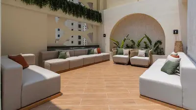 a living room with white couches and plants at Maison Privee - Ultimate Luxury Penthouse with Pool & Marina Views in Dubai