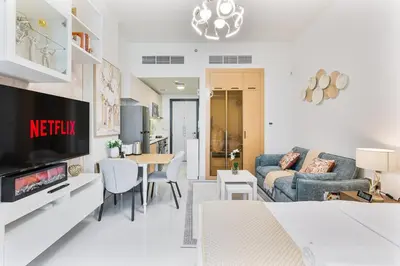 a living room with a couch and a table at Modern Studio Near Miracle Garden & Dubai Hills in Dubai