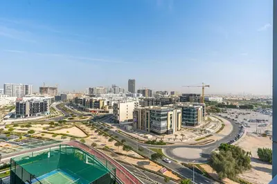an aerial view of a city with buildings and roads at Modern Studio Near Miracle Garden & Dubai Hills in Dubai
