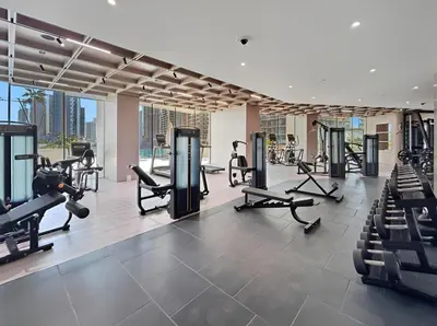 a gym with treadmills and cardio equipment in a building at New Luxury 1BR with Private Pool & Balcony in JVC in Dubai