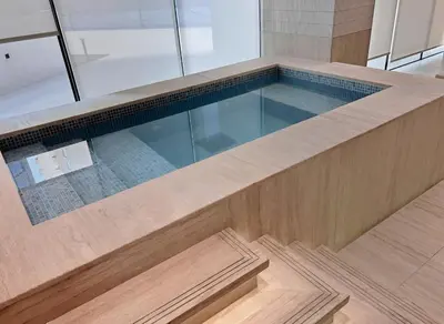 a large swimming pool in a building at New Luxury 1BR with Private Pool & Balcony in JVC in Dubai