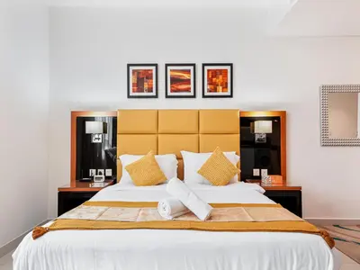 a bedroom with a large bed with towels on it at Savis Homes - Luxury Studio in Business Bay with Amazing Pool - Capital Bay Tower A in Dubai