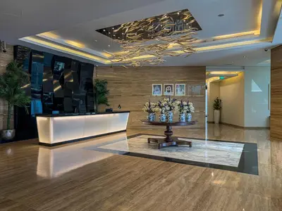 a lobby with a table with flowers on it at Savis Homes - Luxury Studio in Business Bay with Amazing Pool - Capital Bay Tower A in Dubai