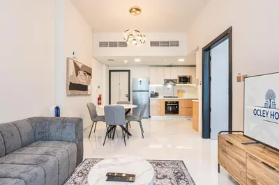 a living room with a couch and a table at Brand New Home with Amazing Facilities in Dubai