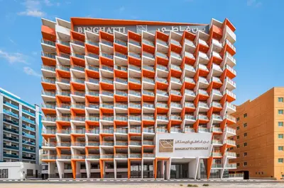 an apartment building with orange and white balconies at Stylish 1BR Apartment Near Silicon Mall & Airport in Dubai