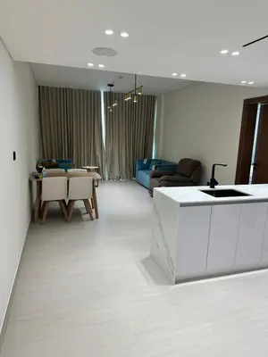 a living room with a kitchen and a living room with a table at Binghatti galaxy in Dubai