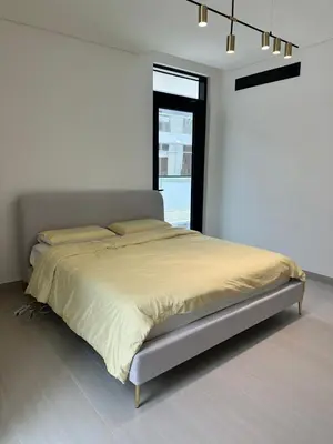 a bed in a white room with a window at Binghatti galaxy in Dubai
