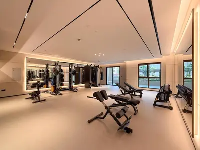 a gym with several treadmills and exercise bikes at GuestReady - 1 BHK | Serene 9th-Floor Escape in Dubai