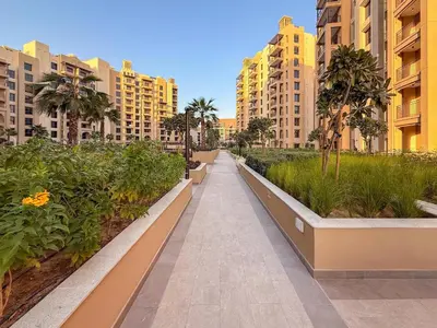 a walkway in a city with tall buildings at GuestReady - 1 BHK | Serene 9th-Floor Escape in Dubai