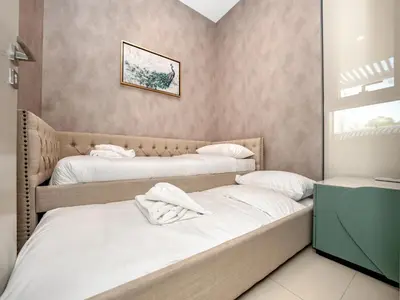 a room with two beds with towels on them at 4BR Villa in Resort-Style Gated Community with Lazy River in Arabian Ranches 3 in Dubai
