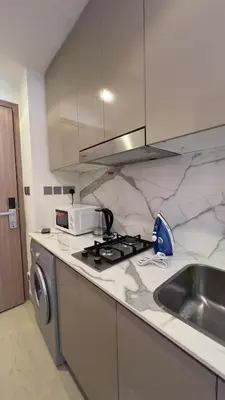 a kitchen with a stove top oven next to a sink at Luxury Studio big Balcony in Dubai