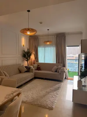 a living room with two couches in front of a window at Marina 1 Bedroom appartment in Dubai