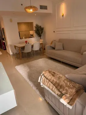 a living room with a couch and a table at Marina 1 Bedroom appartment in Dubai