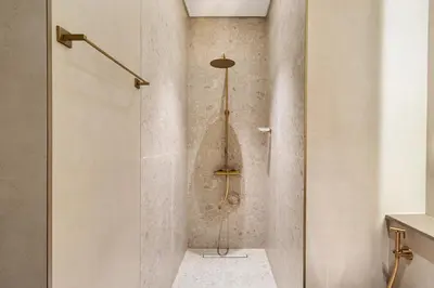 a shower with a glass door in a bathroom at New 1BR Urban Oasis with Pools & City Views in JVC in Dubai