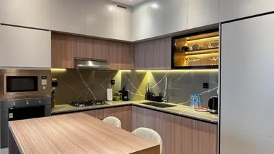 a kitchen with a table and a counter top at Brand New 1BDR with Pool, Jacuzzi, Sauna, Gym in Dubai