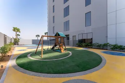 a playground in the middle of a building at Brand New 1BDR with Pool, Jacuzzi, Sauna, Gym in Dubai