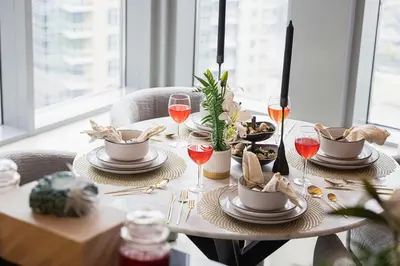 a table with plates of food and glasses of wine at Stunning Burj & Fountain View Downtown 29 Blvd in Dubai