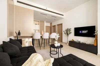 a living room with a couch and a tv at New Chic 1BR Apt with Private Pool & City View in JVC in Dubai