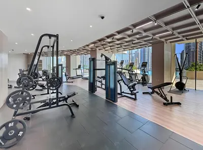 a gym with treadmills and exercise equipment in a building at New Chic 1BR Apt with Private Pool & City View in JVC in Dubai