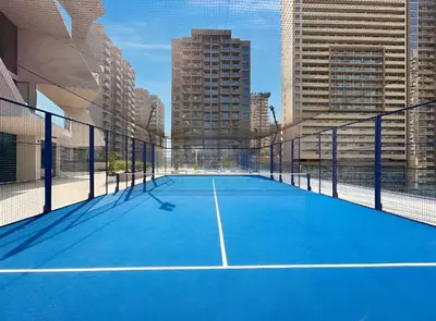 a tennis court in the middle of a city at New Chic 1BR Apt with Private Pool & City View in JVC in Dubai
