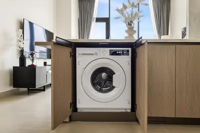 a washer and dryer in a room with a counter at New Skyline 1BR with Private Pool in Binghatti Royale in Dubai