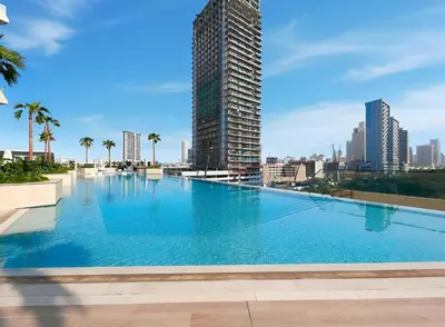a large swimming pool with a city skyline in the background at New Skyline 1BR with Private Pool in Binghatti Royale in Dubai