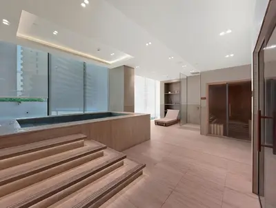 a lobby of a building with stairs and a chair at New Skyline 1BR with Private Pool in Binghatti Royale in Dubai