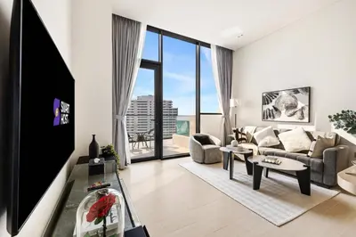 a living room with a couch and a table at New Skyline 1BR with Private Pool in Binghatti Royale in Dubai