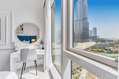 a room with a desk and a large window at GRaNDE 2BR Best BURJ Khalifa & Fountain, Next to DXB Mall in Dubai
