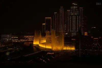 a large fountain in the middle of a city at night at GRaNDE 2BR Best BURJ Khalifa & Fountain, Next to DXB Mall in Dubai