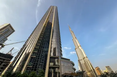 a tall building with a crane in a city at GRaNDE 2BR Best BURJ Khalifa & Fountain, Next to DXB Mall in Dubai