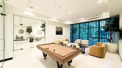 a living room with a pool table in it at 1-Bedroom Apartment - Burj Khalifa -Water View in Dubai