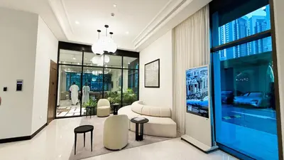 a living room with a couch and chairs in a building at 1-Bedroom Apartment - Burj Khalifa -Water View in Dubai