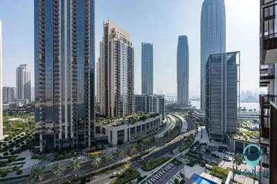 a city with many tall buildings and a highway at Stunning 1BR l Creek Crescent Suite in Dubai