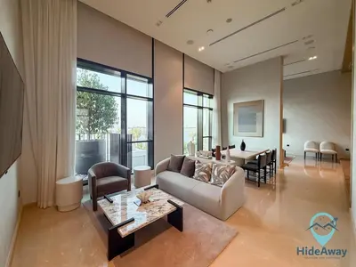 a living room with a couch and a table at Stunning 1BR l Creek Crescent Suite in Dubai