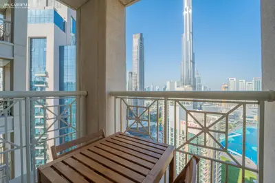 a balcony with a bench and a view of a city at 29 Boulevard-Burj Khalifa View-Downtown Dubai-Lit Apartment in Dubai
